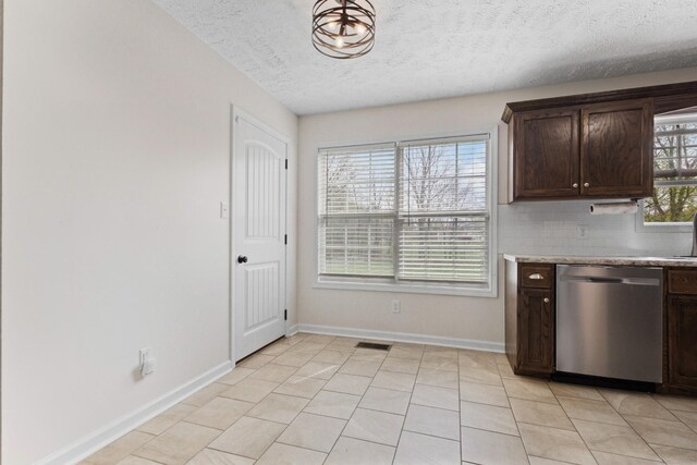 989 Ernest Stewart Dr, Clarksville, TN 37042 - kitchen with dishwasher, dark brown cabinetry, a textured ceiling, light countertops, and decorative backsplash