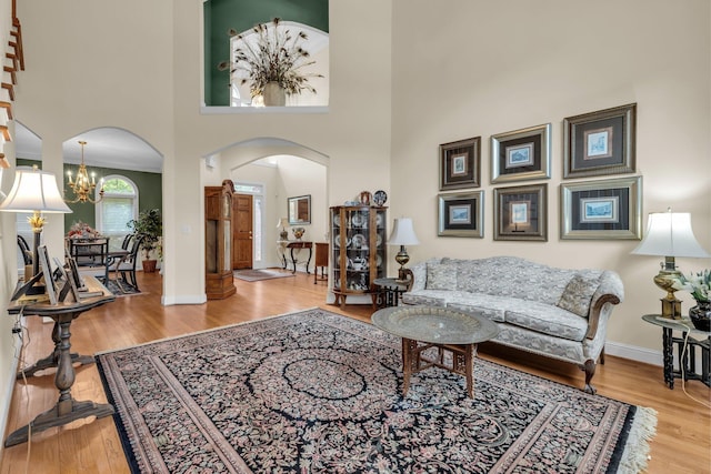 8013 Rosemere Way, Chattanooga, TN 37421 - living room with arched walkways, a chandelier, wood finished floors, and a high ceiling