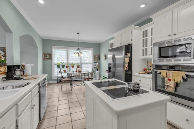 8013 Rosemere Way, Chattanooga, TN 37421 - kitchen featuring stainless steel appliances, white cabinetry, glass insert cabinets, ornamental molding, and light countertops