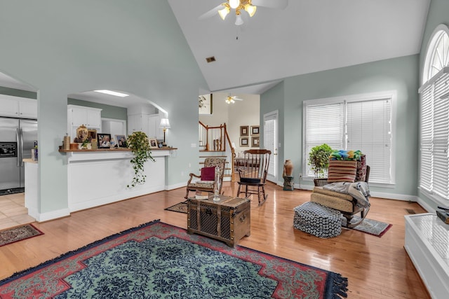 8013 Rosemere Way, Chattanooga, TN 37421 - living area with ceiling fan, high vaulted ceiling, light wood finished floors, stairs, and arched walkways