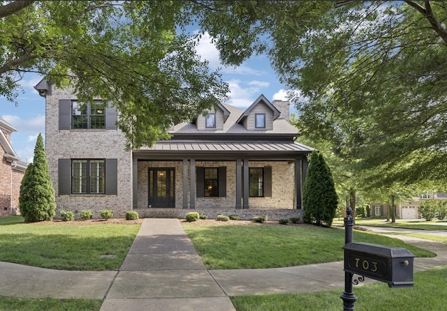 703 Welsh Ln, Franklin, TN 37064 - view of front of property with brick siding, covered porch, a front yard, a standing seam roof, and a metal roof