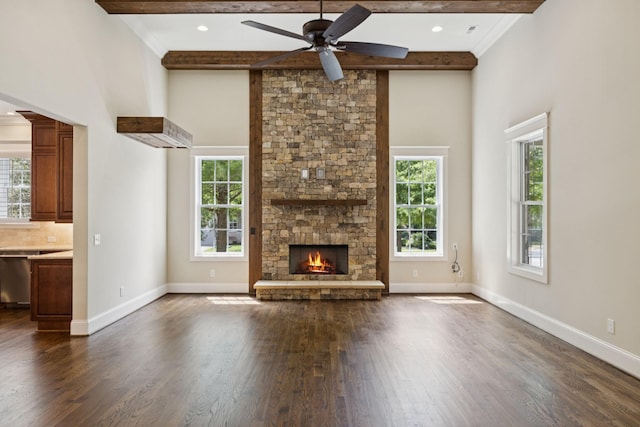 703 Welsh Ln, Franklin, TN 37064 - unfurnished living room with plenty of natural light, a high ceiling, dark wood-style flooring, beamed ceiling, and a stone fireplace