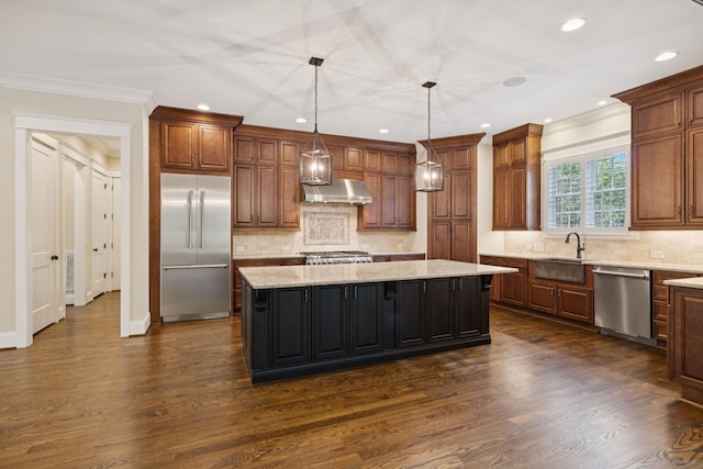 703 Welsh Ln, Franklin, TN 37064 - kitchen with appliances with stainless steel finishes, exhaust hood, a center island, dark wood-style floors, and light stone countertops