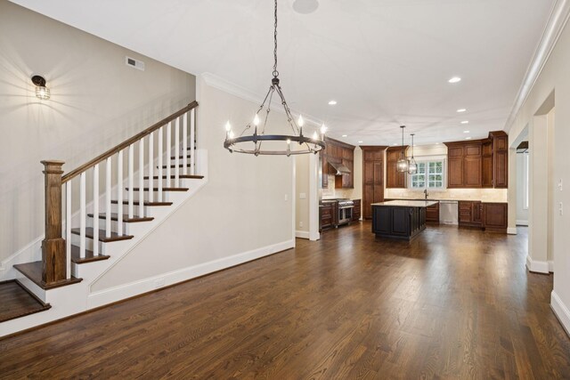 703 Welsh Ln, Franklin, TN 37064 - unfurnished living room with a chandelier, recessed lighting, dark wood-style flooring, stairway, and ornamental molding
