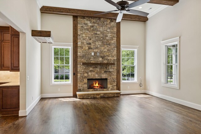 703 Welsh Ln, Franklin, TN 37064 - unfurnished living room with dark wood finished floors, a stone fireplace, beamed ceiling, a ceiling fan, and a towering ceiling