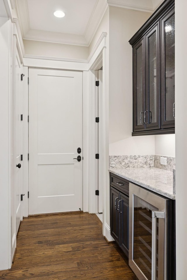 703 Welsh Ln, Franklin, TN 37064 - indoor dry bar with beverage cooler, dark wood-style flooring, ornamental molding, and recessed lighting