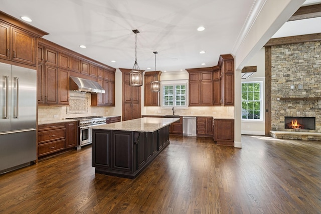 703 Welsh Ln, Franklin, TN 37064 - kitchen with premium appliances, range hood, a center island, dark wood-style flooring, and ornamental molding