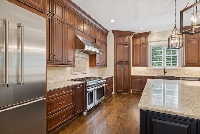703 Welsh Ln, Franklin, TN 37064 - kitchen with high quality appliances, exhaust hood, light stone countertops, dark wood-type flooring, and backsplash