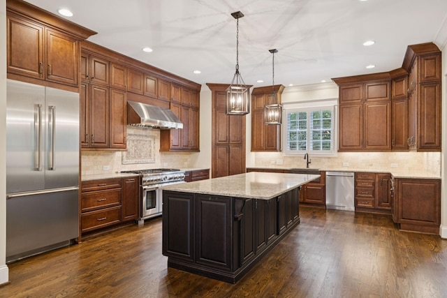 703 Welsh Ln, Franklin, TN 37064 - kitchen featuring high end appliances, wall chimney range hood, a kitchen island, dark wood finished floors, and recessed lighting