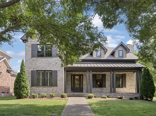 703 Welsh Ln, Franklin, TN 37064 - view of front of house featuring brick siding, a porch, a front yard, and a standing seam roof