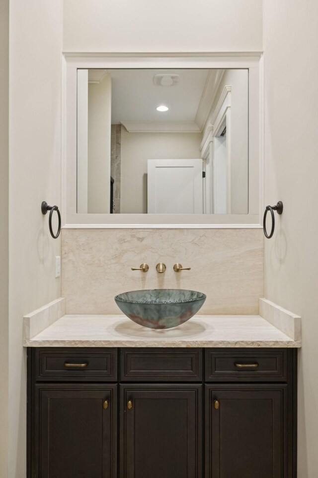 703 Welsh Ln, Franklin, TN 37064 - bathroom with vanity, backsplash, and ornamental molding
