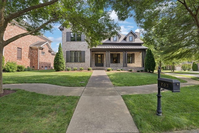 703 Welsh Ln, Franklin, TN 37064 - view of front of property with a front lawn, a standing seam roof, brick siding, covered porch, and a chimney