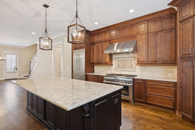 703 Welsh Ln, Franklin, TN 37064 - kitchen featuring premium appliances, wall chimney exhaust hood, a chandelier, a center island, and decorative backsplash