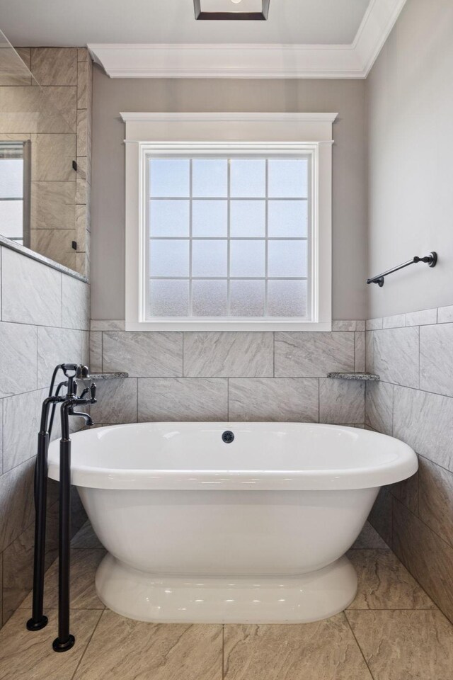 703 Welsh Ln, Franklin, TN 37064 - bathroom with tile walls, crown molding, a freestanding bath, tile patterned flooring, and wainscoting