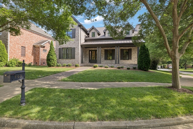 703 Welsh Ln, Franklin, TN 37064 - view of front of house featuring brick siding, a front yard, a standing seam roof, and a porch