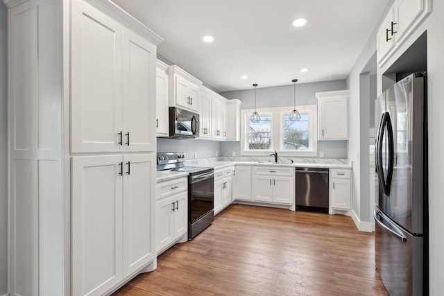 222 Groh St, Lawrenceburg, TN 38464 - kitchen featuring appliances with stainless steel finishes, light countertops, white cabinetry, light wood-style floors, and recessed lighting
