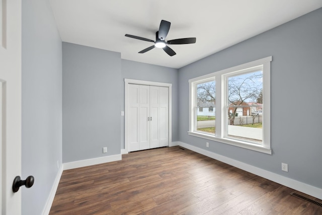 222 Groh St, Lawrenceburg, TN 38464 - unfurnished bedroom with dark wood-type flooring, a closet, and a ceiling fan