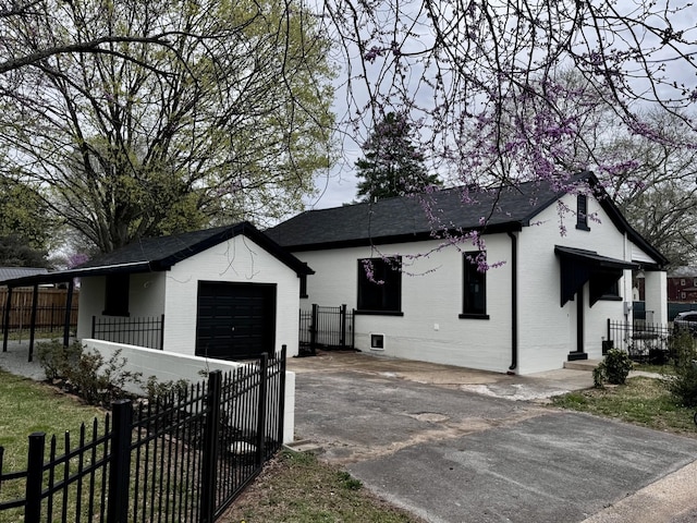 222 Groh St, Lawrenceburg, TN 38464 - view of side of home with asphalt driveway, a garage, brick siding, and a shingled roof