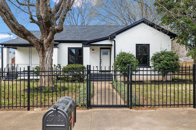 222 Groh St, Lawrenceburg, TN 38464 - view of front of house featuring a fenced front yard, a shingled roof, brick siding, and a gate