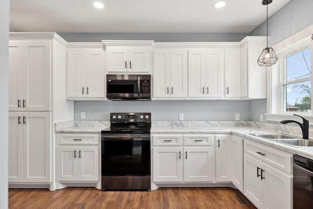 222 Groh St, Lawrenceburg, TN 38464 - kitchen with stainless steel appliances, white cabinets, recessed lighting, decorative light fixtures, and wood finished floors
