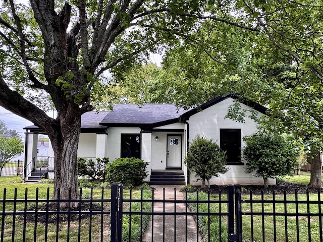 222 Groh St, Lawrenceburg, TN 38464 - ranch-style home featuring brick siding, a fenced front yard, and roof with shingles