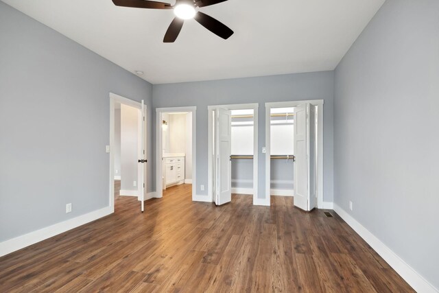 222 Groh St, Lawrenceburg, TN 38464 - unfurnished bedroom featuring dark wood finished floors, a ceiling fan, and multiple closets