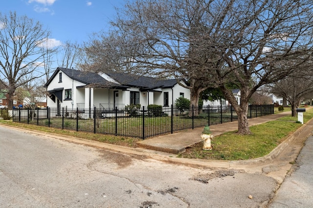 222 Groh St, Lawrenceburg, TN 38464 - view of front facade with stucco siding, a fenced front yard, and a shingled roof