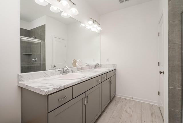 3716 Capstone Dr, Murfreesboro, TN 37128 - full bathroom with double vanity, tiled shower, and wood finished floors