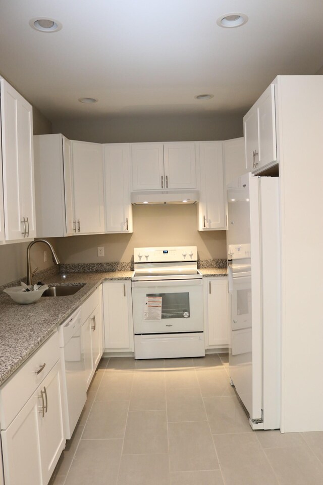 721 Poplar St, Columbia, TN 38401 - kitchen featuring white appliances, under cabinet range hood, white cabinetry, light tile patterned floors, and recessed lighting
