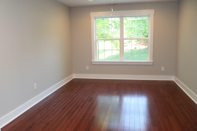 721 Poplar St, Columbia, TN 38401 - spare room featuring baseboards and dark wood-style flooring