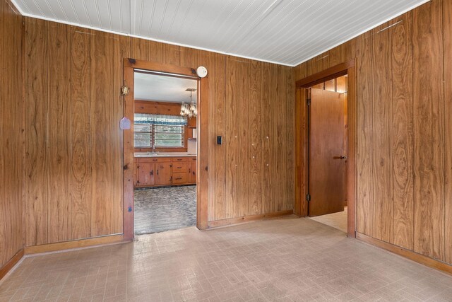 75 Lakeside Dr, Rock Island, TN 38581 - unfurnished room featuring wood walls and a chandelier