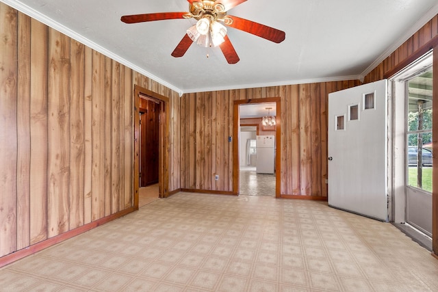 75 Lakeside Dr, Rock Island, TN 38581 - unfurnished room featuring crown molding, wood walls, light flooring, a ceiling fan, and a chandelier