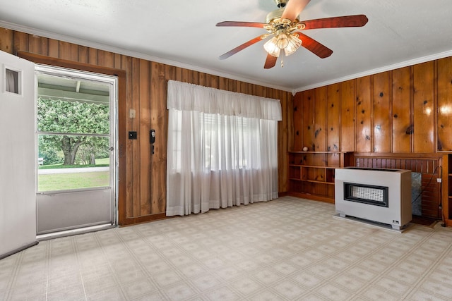 75 Lakeside Dr, Rock Island, TN 38581 - unfurnished living room featuring heating unit, crown molding, wood walls, a fireplace, and a ceiling fan