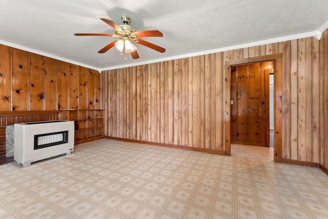 75 Lakeside Dr, Rock Island, TN 38581 - unfurnished living room featuring heating unit, crown molding, a fireplace, wood walls, and a ceiling fan