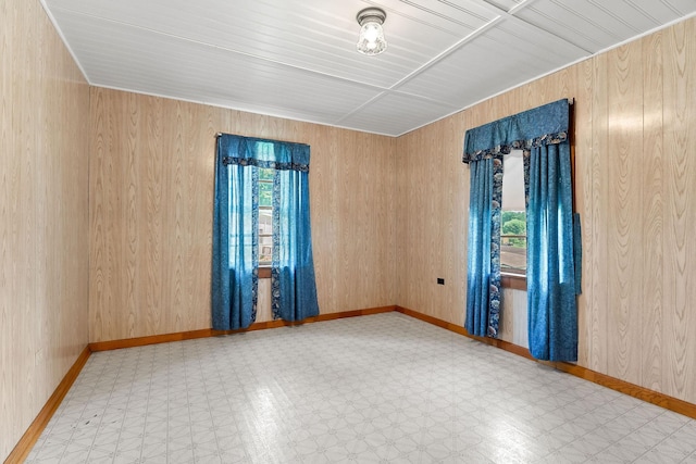 75 Lakeside Dr, Rock Island, TN 38581 - spare room featuring tile patterned floors and wooden walls