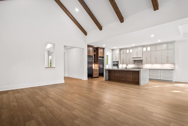 6628 Bethesda Arno Rd, Thompsons Station, TN 37179 - kitchen with stainless steel appliances, light countertops, high vaulted ceiling, open floor plan, and recessed lighting