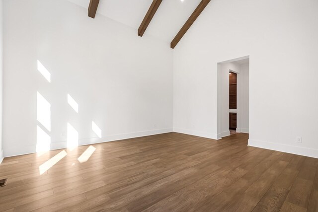 6628 Bethesda Arno Rd, Thompsons Station, TN 37179 - spare room featuring beamed ceiling, wood finished floors, and high vaulted ceiling