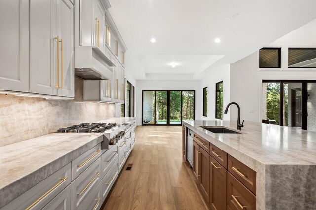 6628 Bethesda Arno Rd, Thompsons Station, TN 37179 - kitchen with stainless steel gas cooktop, light wood-style flooring, a kitchen island with sink, backsplash, and recessed lighting
