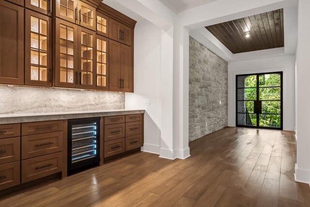 6628 Bethesda Arno Rd, Thompsons Station, TN 37179 - bar area featuring beverage cooler, dark wood-type flooring, tasteful backsplash, and a tray ceiling