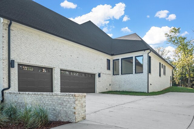 6628 Bethesda Arno Rd, Thompsons Station, TN 37179 - view of property exterior featuring driveway, brick siding, and an attached garage
