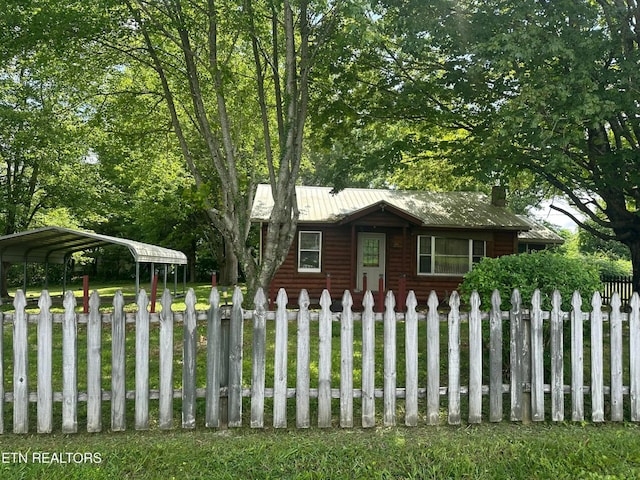 538 Harding Rd, Jamestown, TN 38556 - view of front facade with a fenced front yard, faux log siding, a carport, and a metal roof