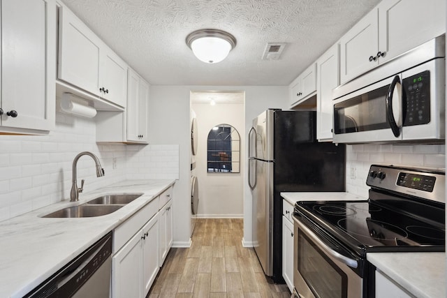 420 Elysian Fields Rd Unit C3, Nashville, TN 37211 - kitchen featuring appliances with stainless steel finishes, white cabinetry, light countertops, light wood finished floors, and decorative backsplash