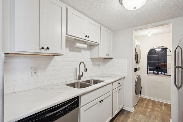 420 Elysian Fields Rd Unit C3, Nashville, TN 37211 - kitchen with stacked washer and clothes dryer, dishwasher, freestanding refrigerator, white cabinets, and a textured ceiling