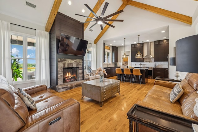 4080 Coles Ferry Pike, Lebanon, TN 37087 - living area featuring a ceiling fan, a stone fireplace, high vaulted ceiling, light wood finished floors, and beamed ceiling