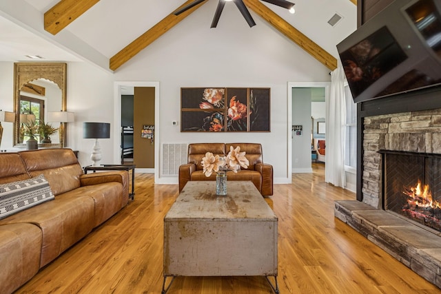 4080 Coles Ferry Pike, Lebanon, TN 37087 - living area featuring a stone fireplace, beam ceiling, light wood finished floors, a ceiling fan, and high vaulted ceiling