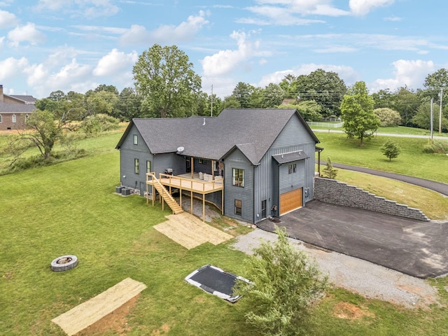4080 Coles Ferry Pike, Lebanon, TN 37087 - back of property with a fire pit, a wooden deck, driveway, a garage, and a lawn
