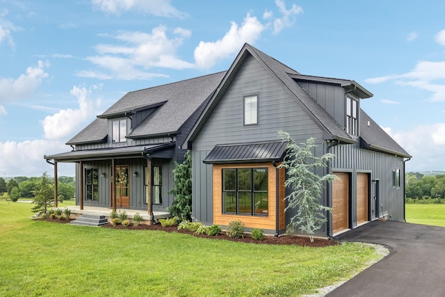 4080 Coles Ferry Pike, Lebanon, TN 37087 - modern farmhouse style home with board and batten siding, covered porch, a shingled roof, and a front lawn