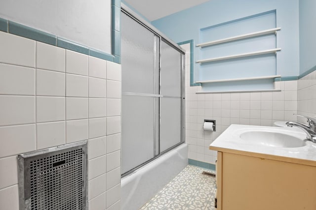 3841 Rollingwood Dr, Chattanooga, TN 37406 - bathroom with tile walls, bath / shower combo with glass door, vanity, tile patterned floors, and wainscoting