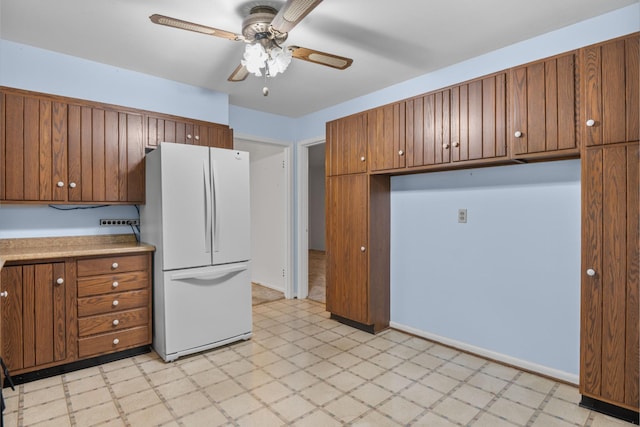 3841 Rollingwood Dr, Chattanooga, TN 37406 - kitchen featuring freestanding refrigerator, light flooring, a ceiling fan, and brown cabinets