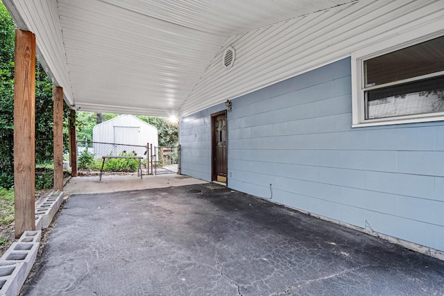 3841 Rollingwood Dr, Chattanooga, TN 37406 - view of patio with a carport, an outbuilding, and asphalt driveway